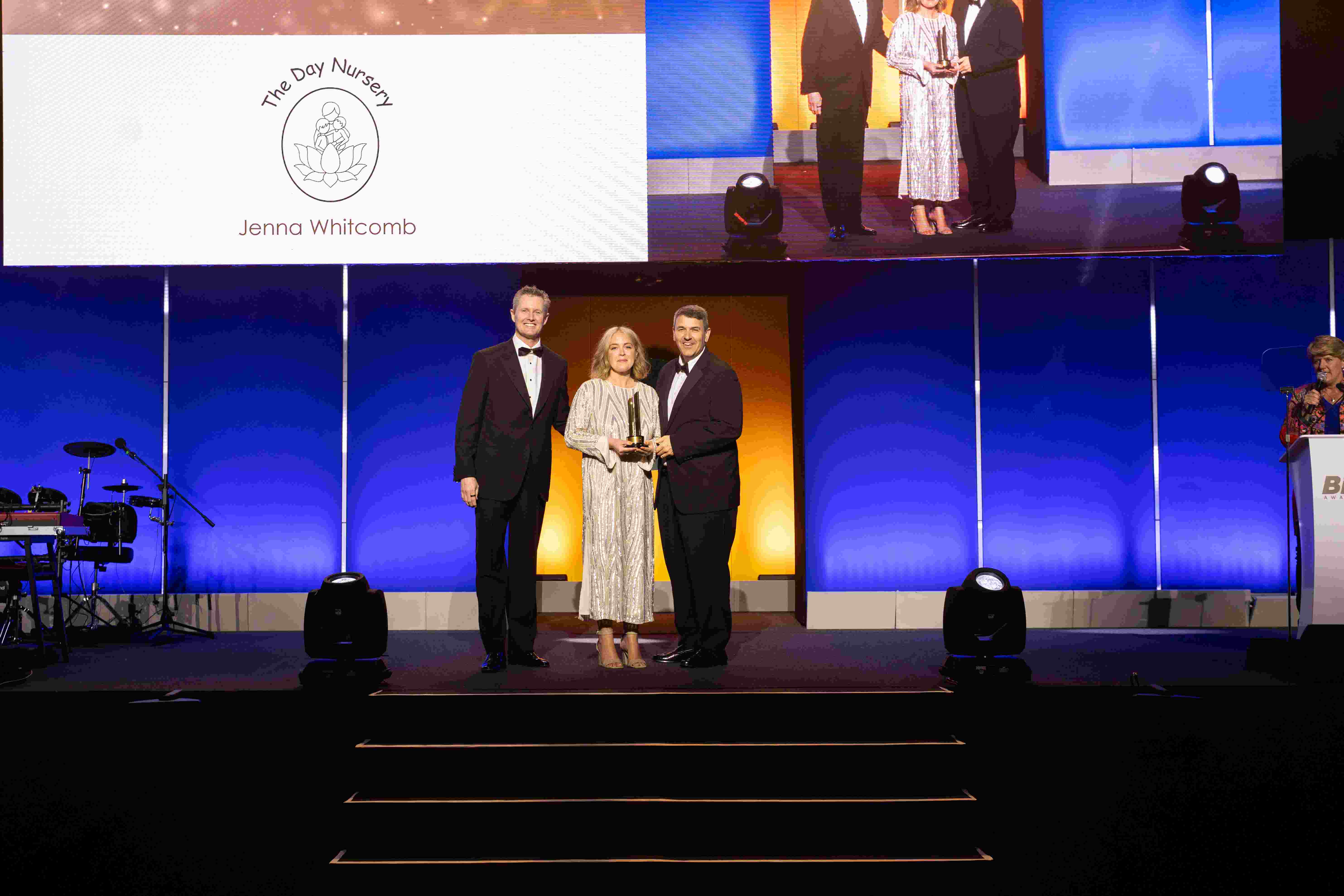 Winning an Award at BizX - Left to right (Brad Sugars Founder of ActionCOACH, Jenna Whitcombe and Lucas Vigilante) 